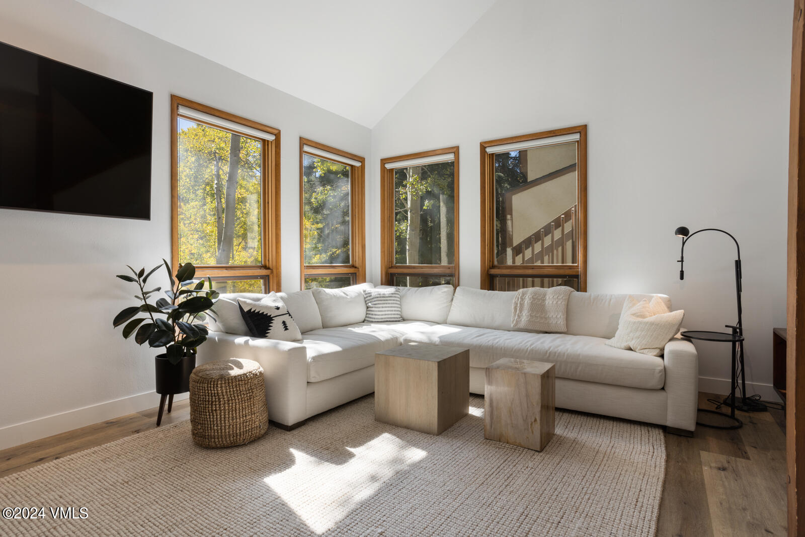 a living room with furniture tv and a large window