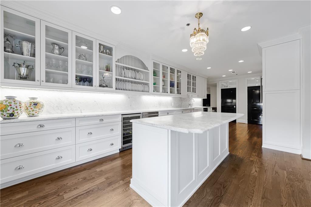 a kitchen with a stove and a chandelier