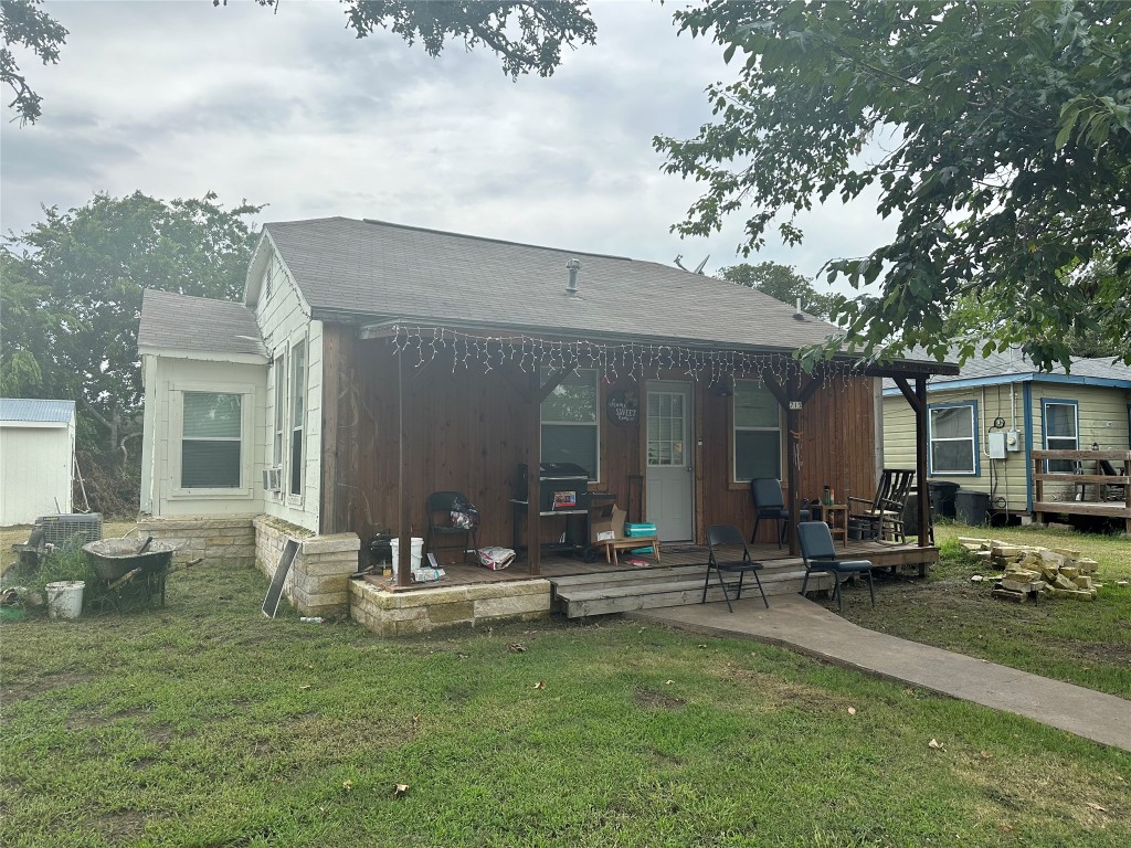 a view of a house with backyard porch and sitting area