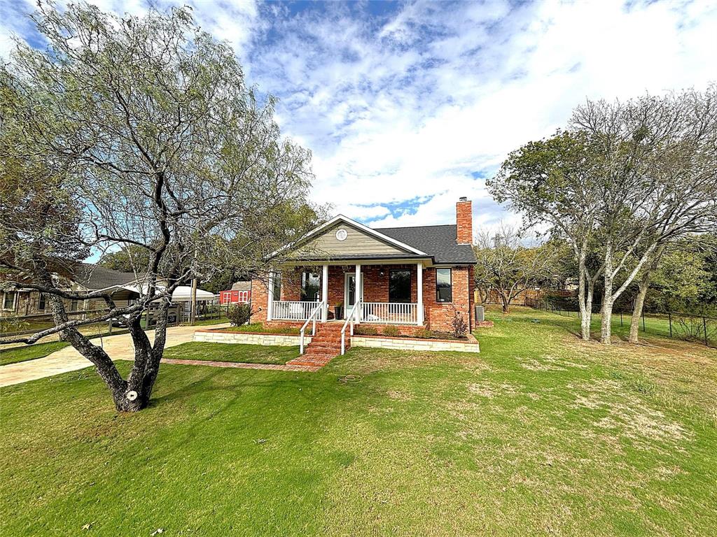 a view of a house with a yard porch and sitting area