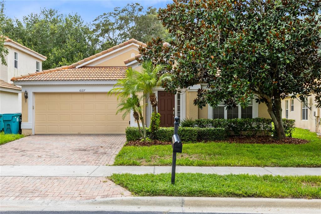 a front view of a house with a yard and garage