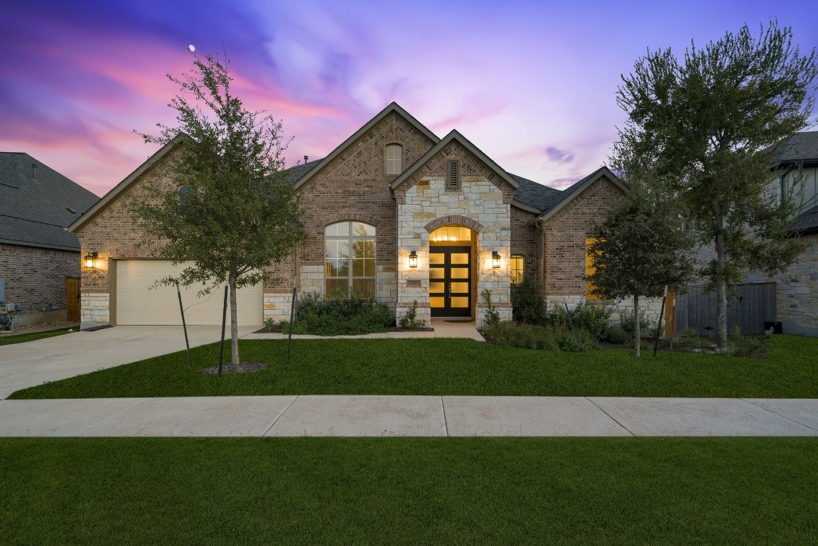 a front view of a house with a yard