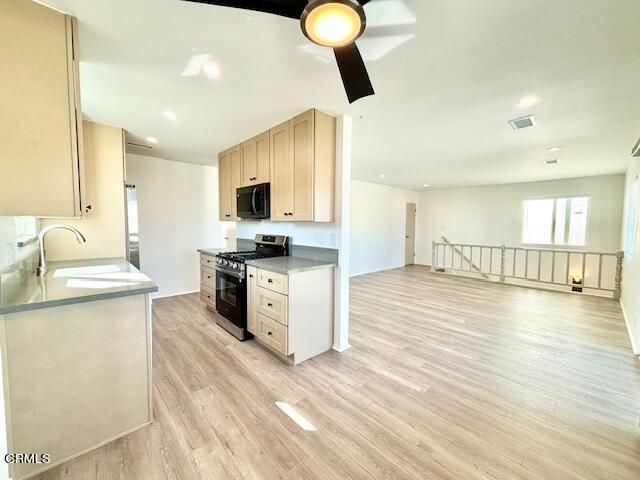 a kitchen with granite countertop a sink appliances cabinets and a counter top space