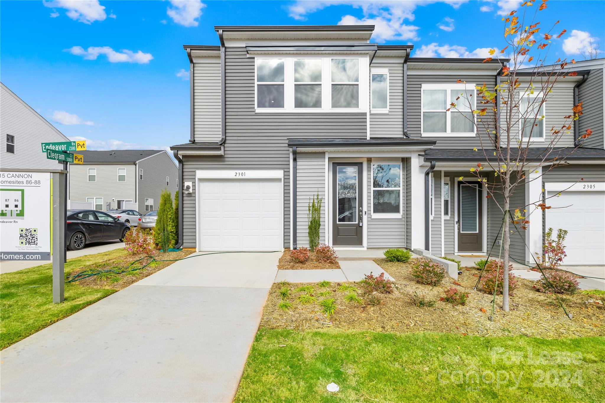 a front view of a house with a yard outdoor seating and garage