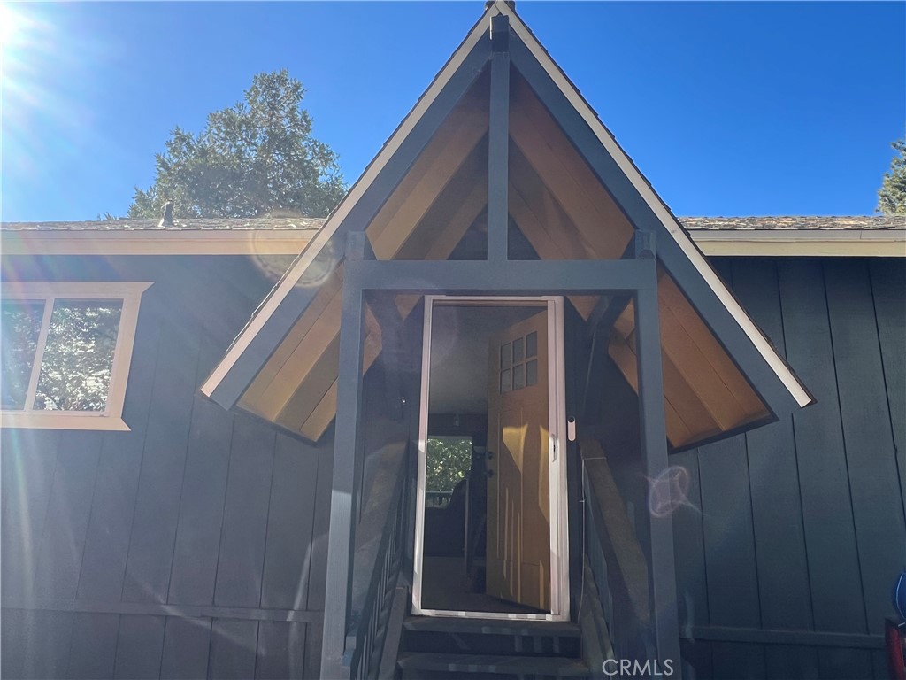 a view of wooden house with a small space