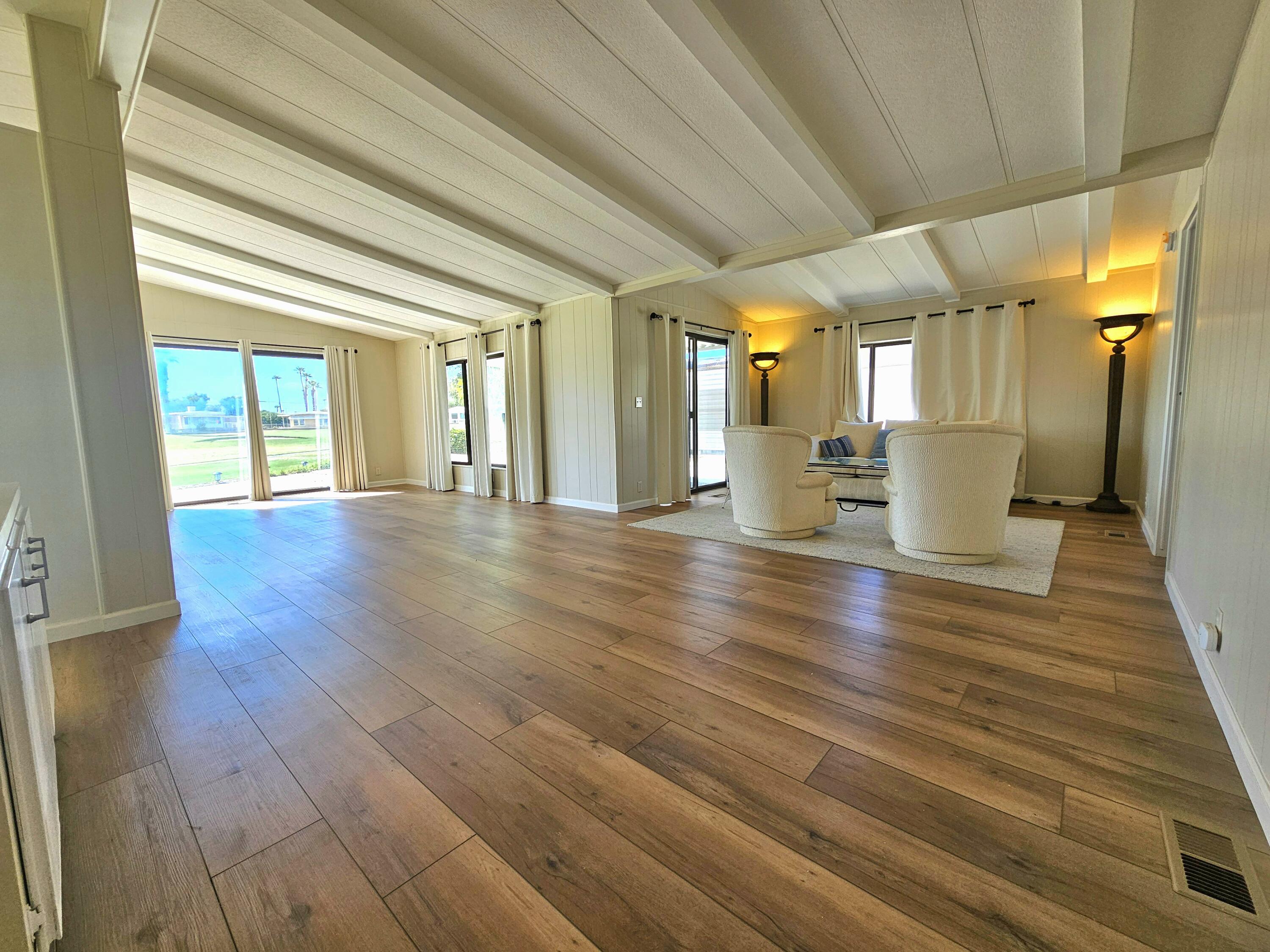 a view of an entryway with wooden floor