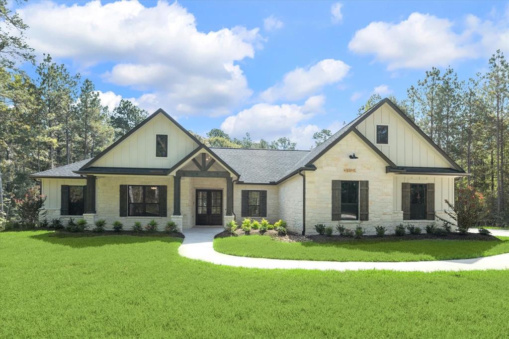 a front view of house with yard and green space