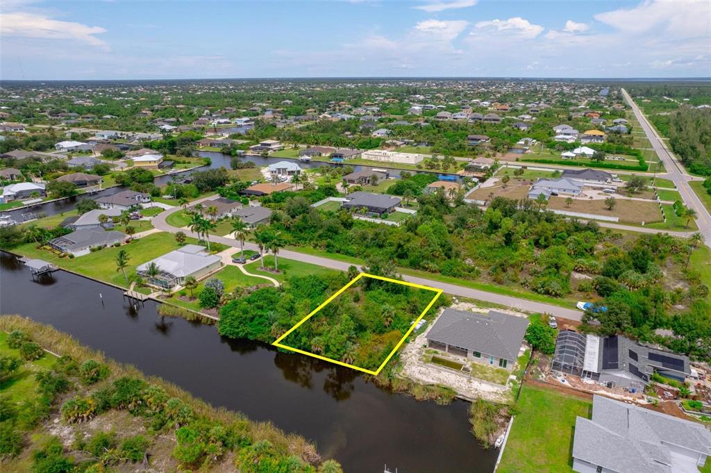 an aerial view of residential houses with outdoor space and a lake view