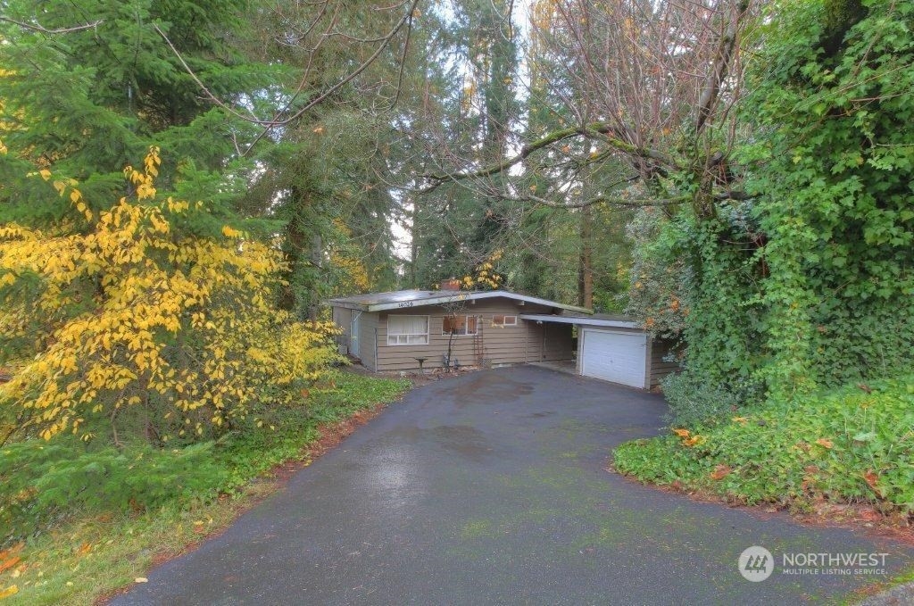 a backyard of a house with lots of green space and fountain