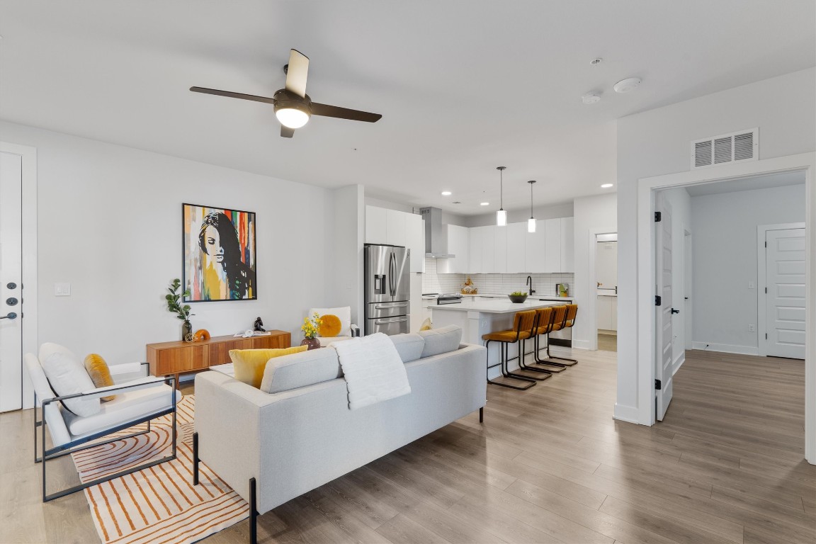 A chic, open and airy interior with sleek laminate flooring and high ceilings throughout.