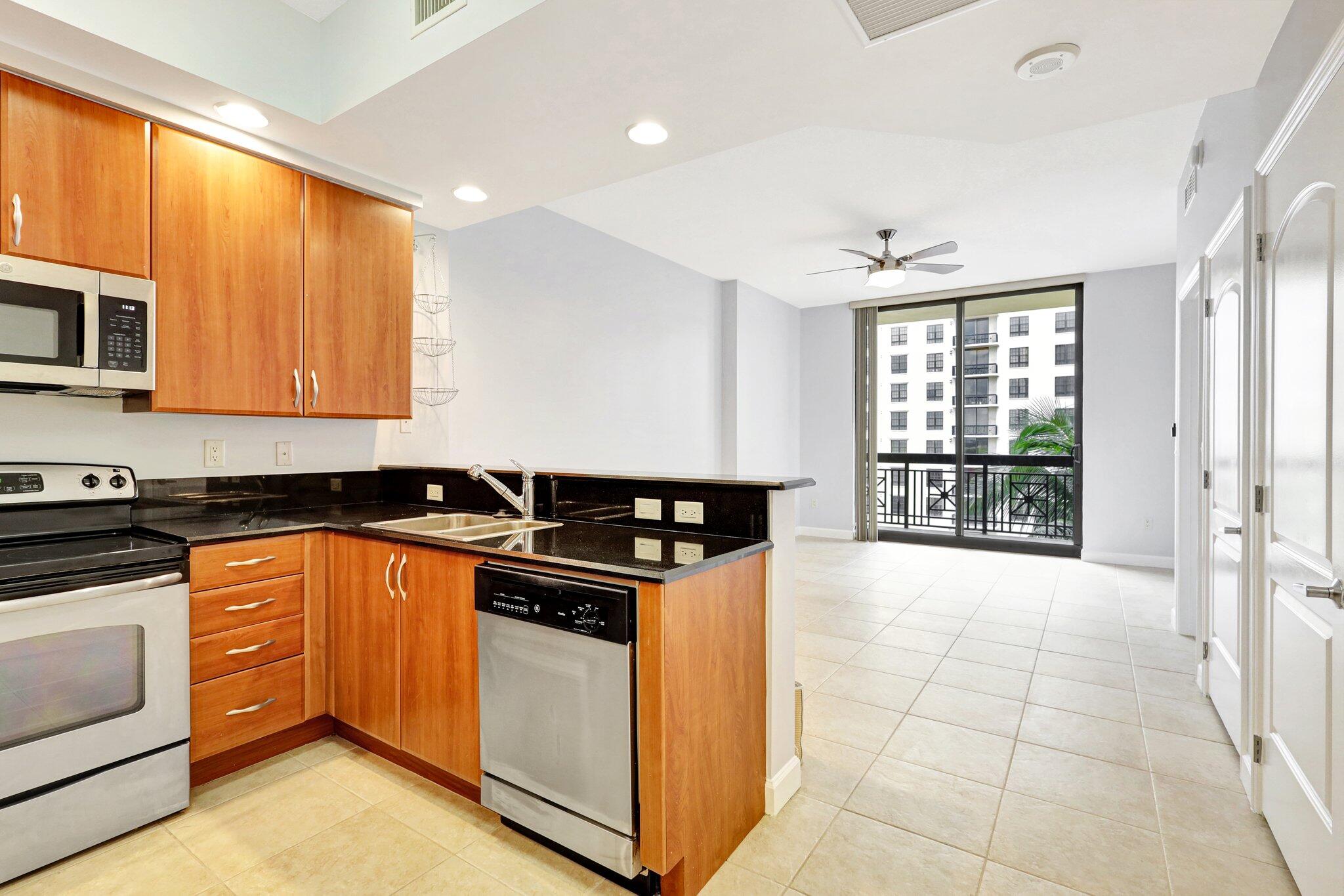 a kitchen with stainless steel appliances granite countertop a stove and a sink