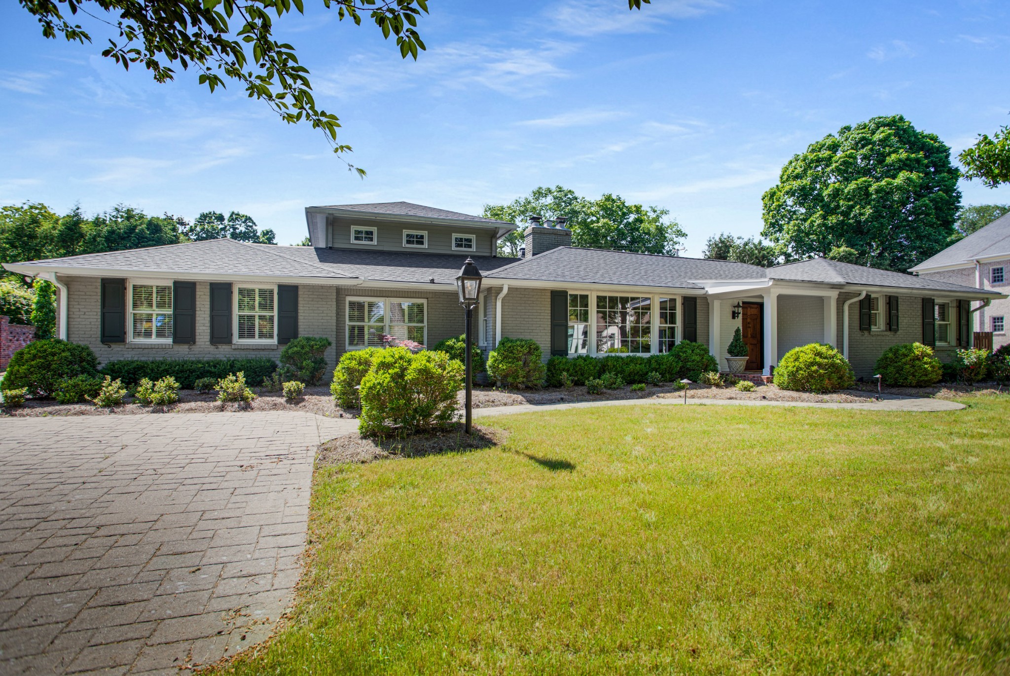 a front view of a house with yard patio and green space