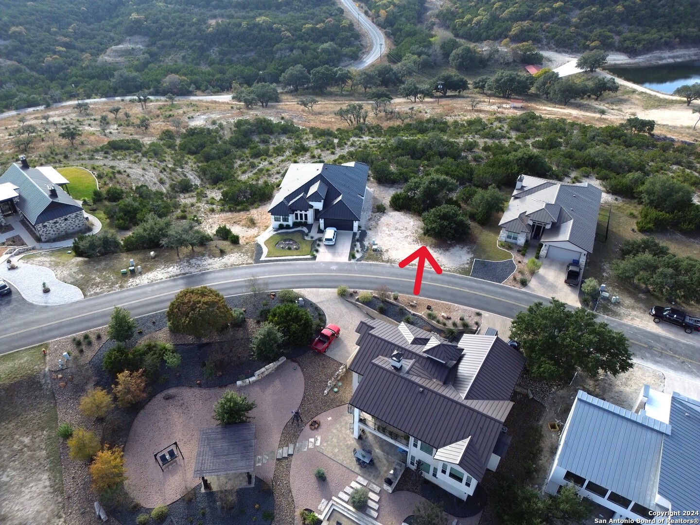 an aerial view of a house with a yard basket ball court and outdoor seating