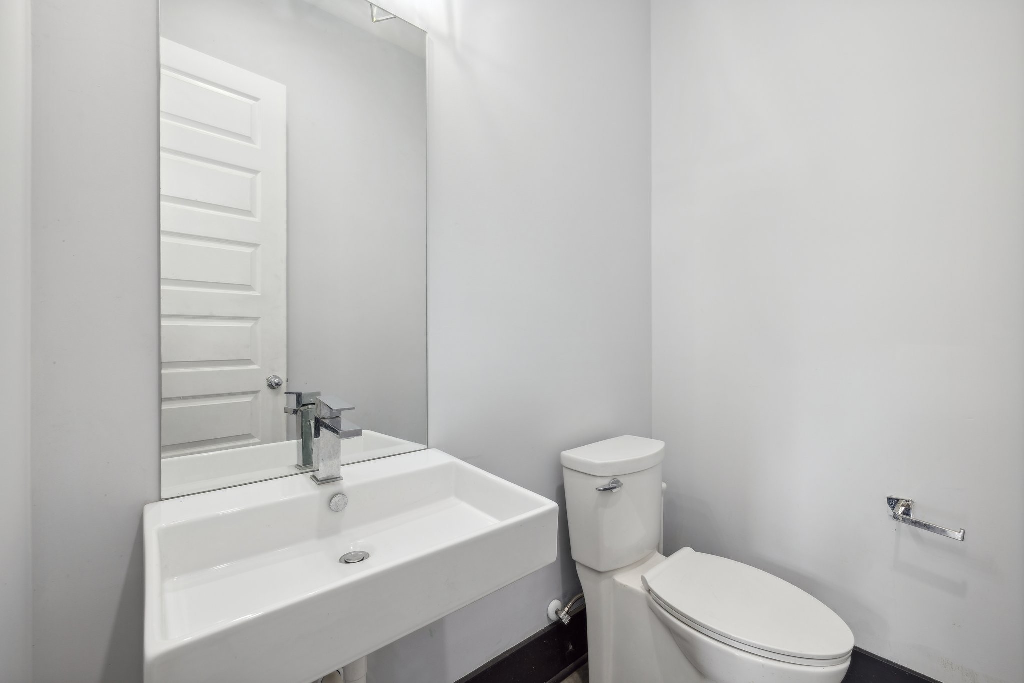 a bathroom with a sink a toilet and mirror