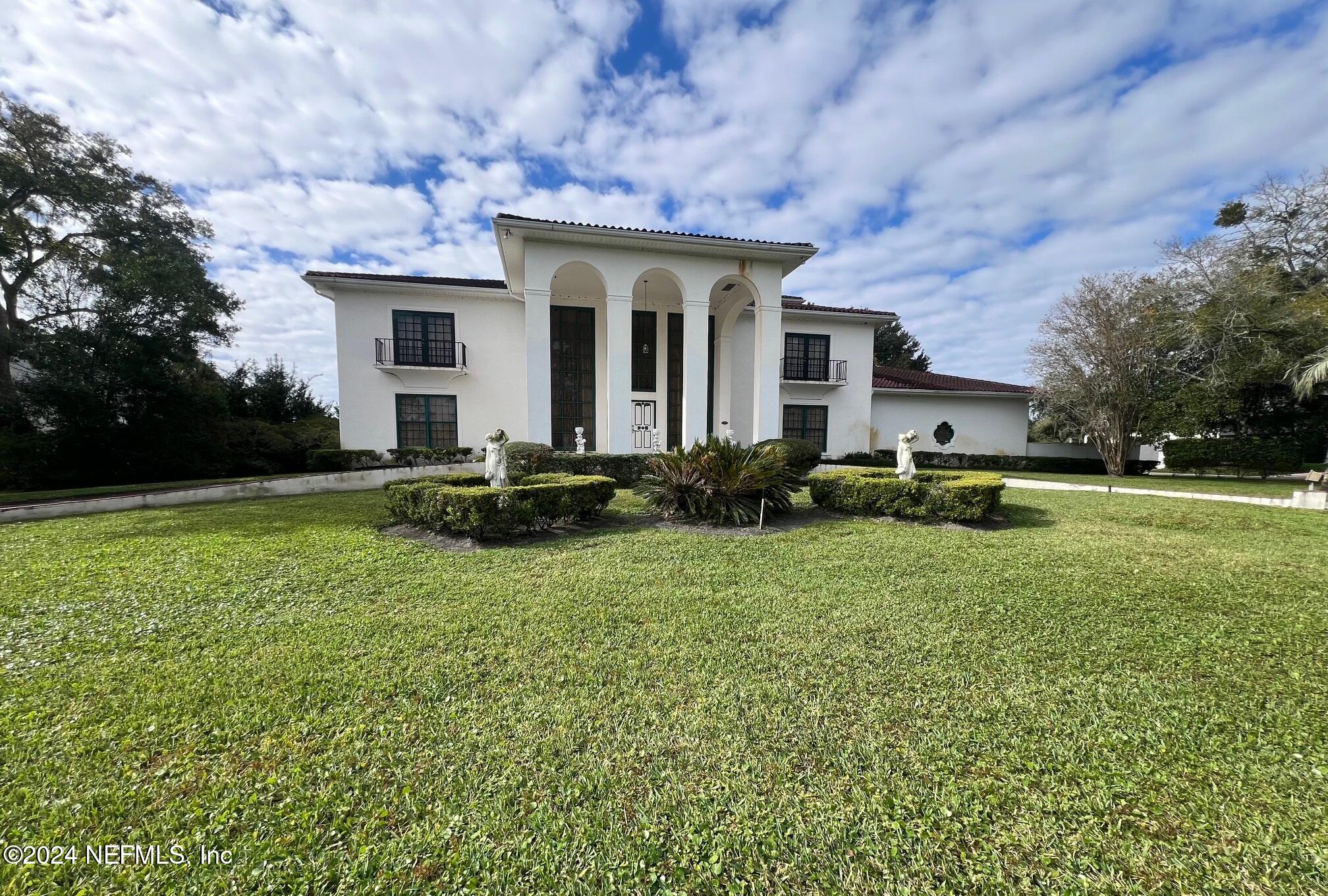 a front view of house with yard and green space