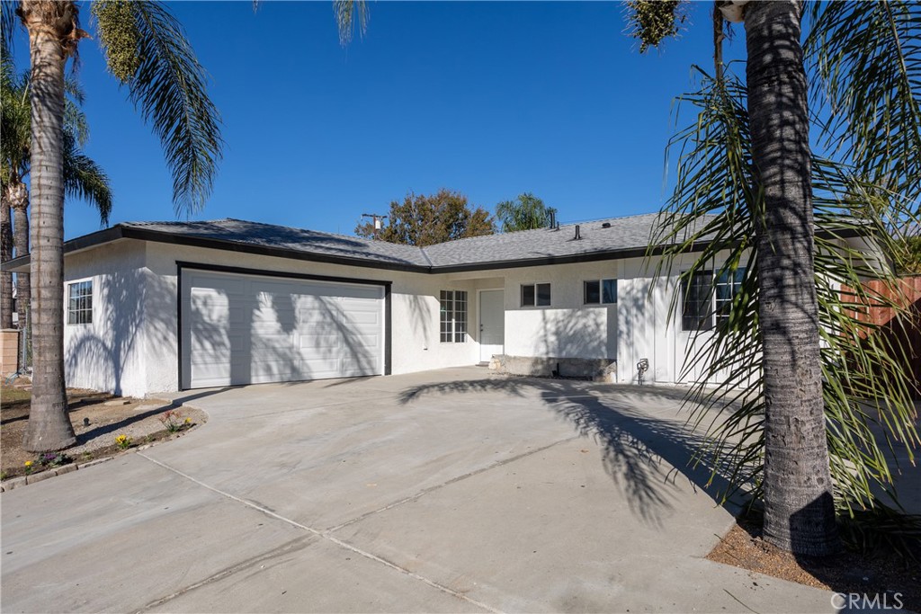 a view of house with backyard and outdoor seating