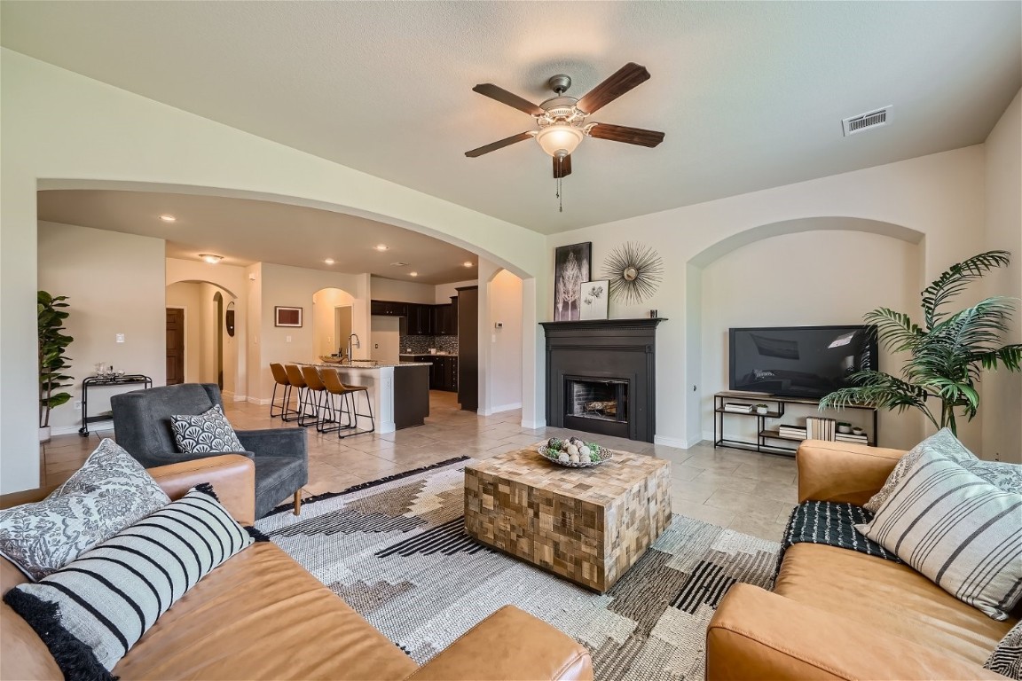 a living room with furniture a fireplace and a flat screen tv