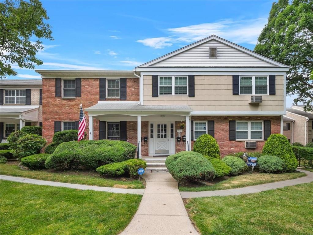 View of front of house featuring a front yard and a porch