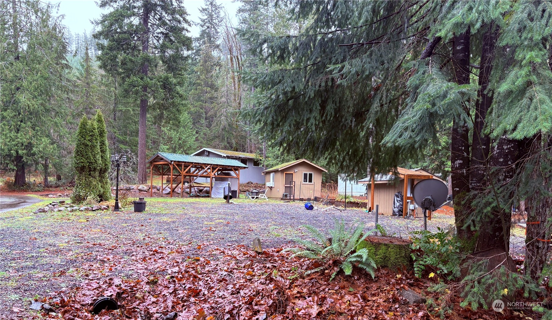 a front view of a house with a yard and trees