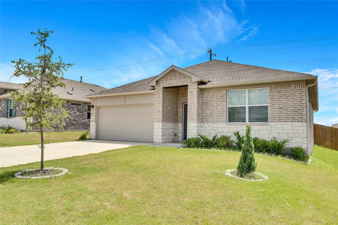 a front view of a house with a yard