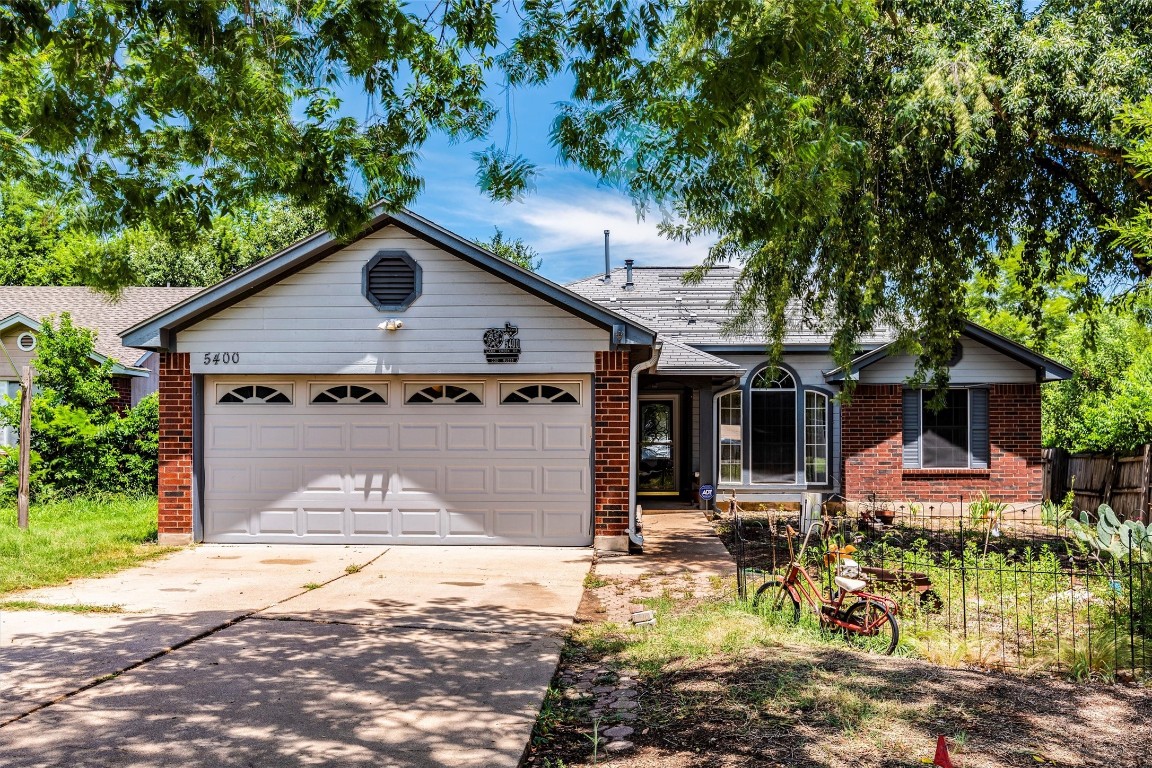 a front view of a house with a yard garage and outdoor seating