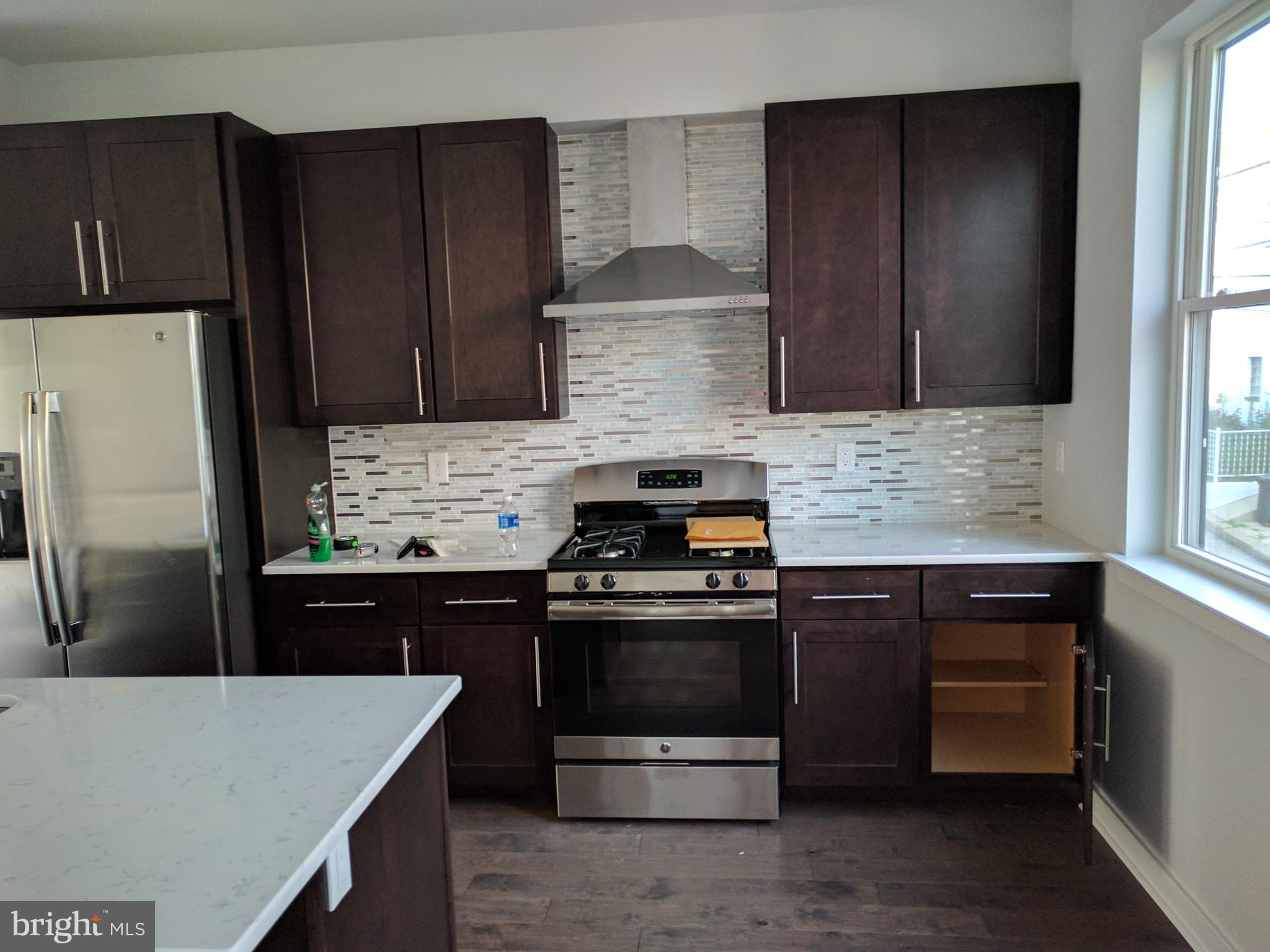 a kitchen with a refrigerator stove and sink