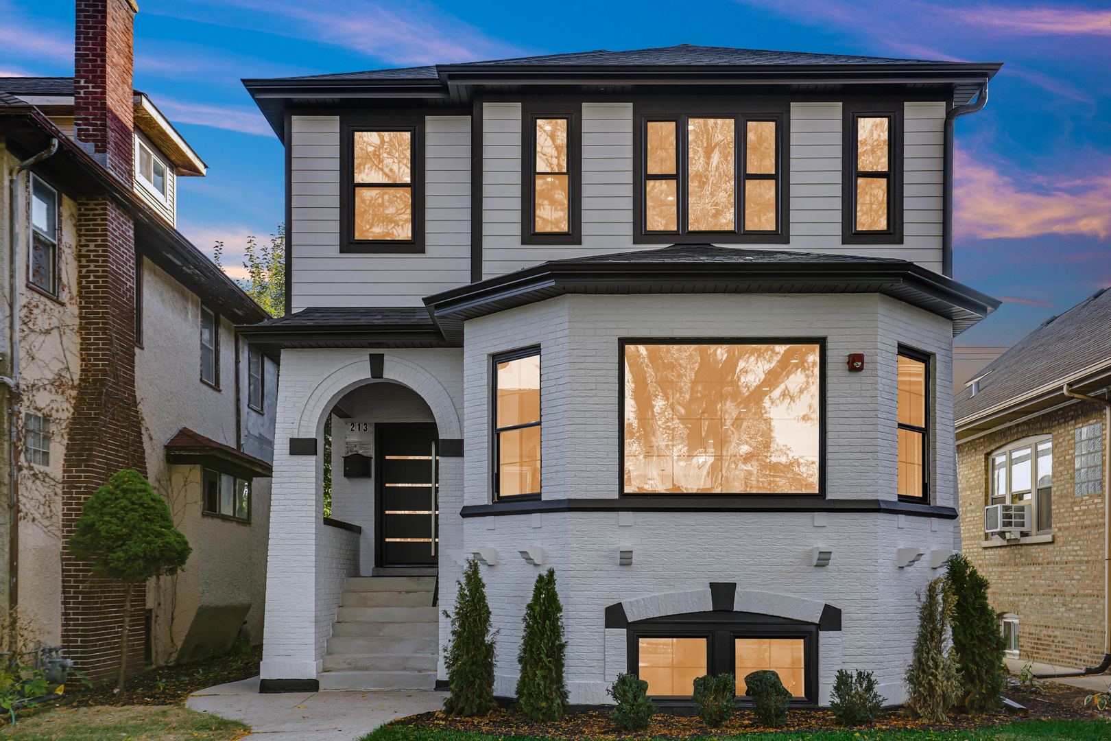 a front view of a house with many windows