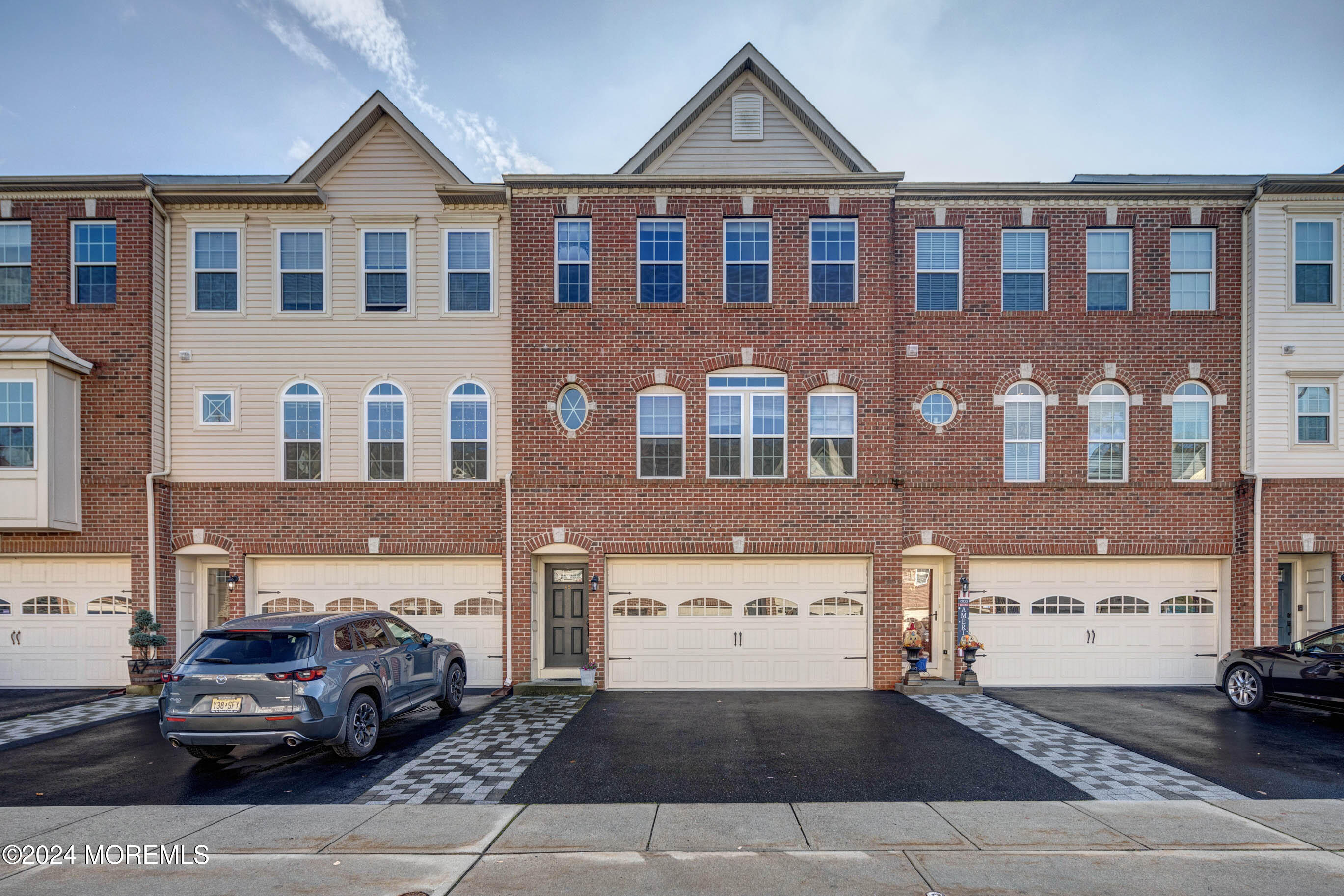 a front view of a house with parking space