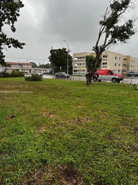 a view of outdoor space with playground and green space