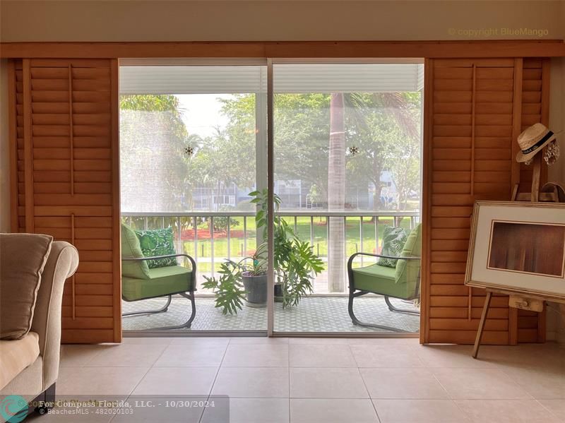 a living room with furniture and a floor to ceiling window