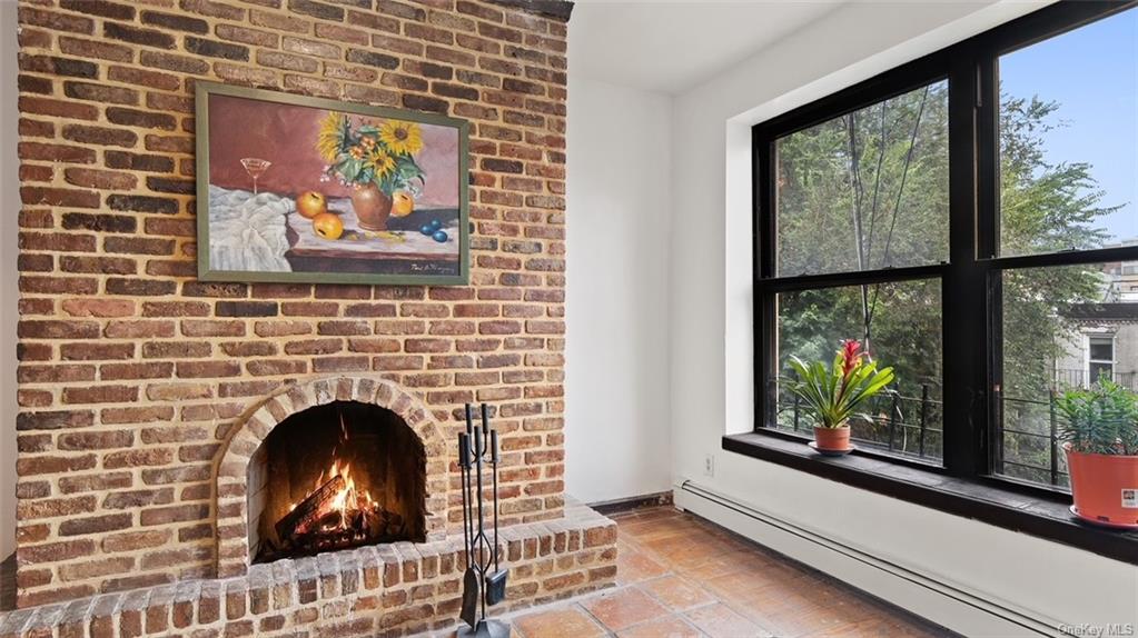 Interior details featuring a baseboard heating unit and a fireplace