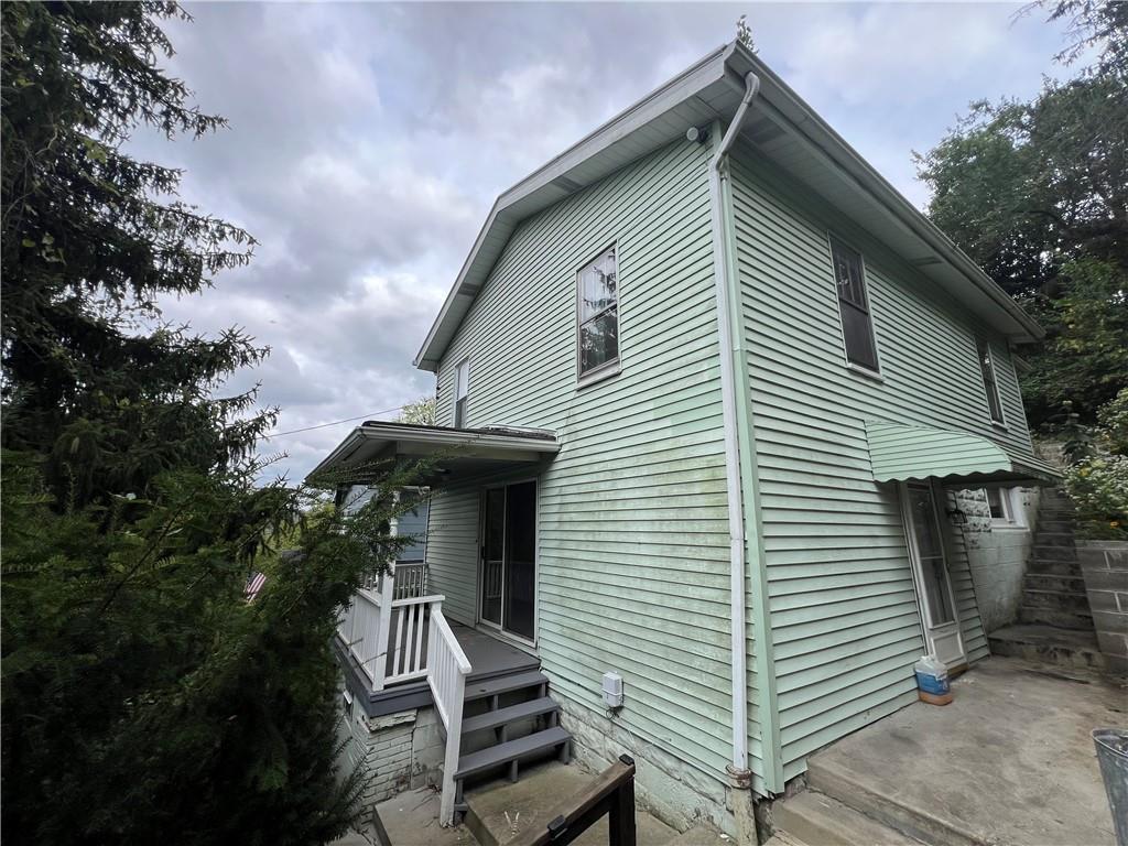 a front view of a house with stairs