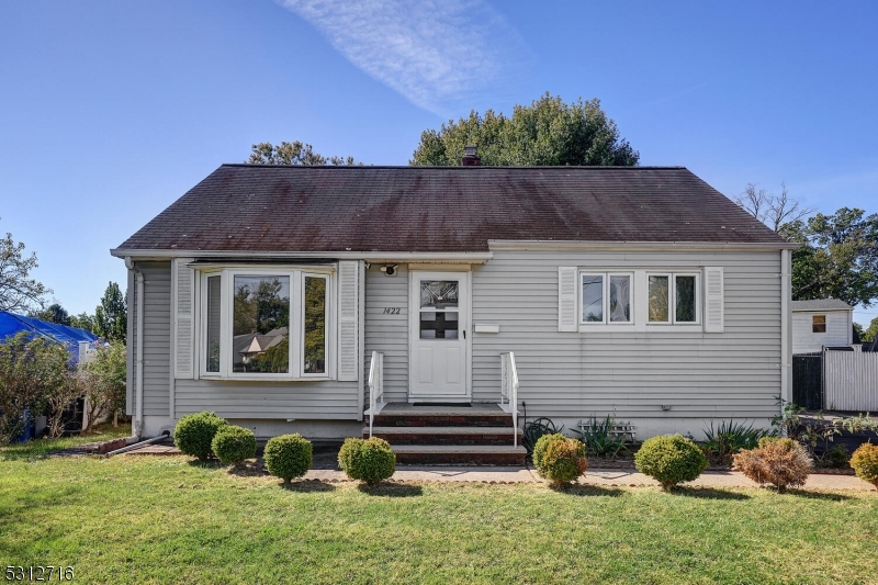 a view of house with yard and outdoor seating