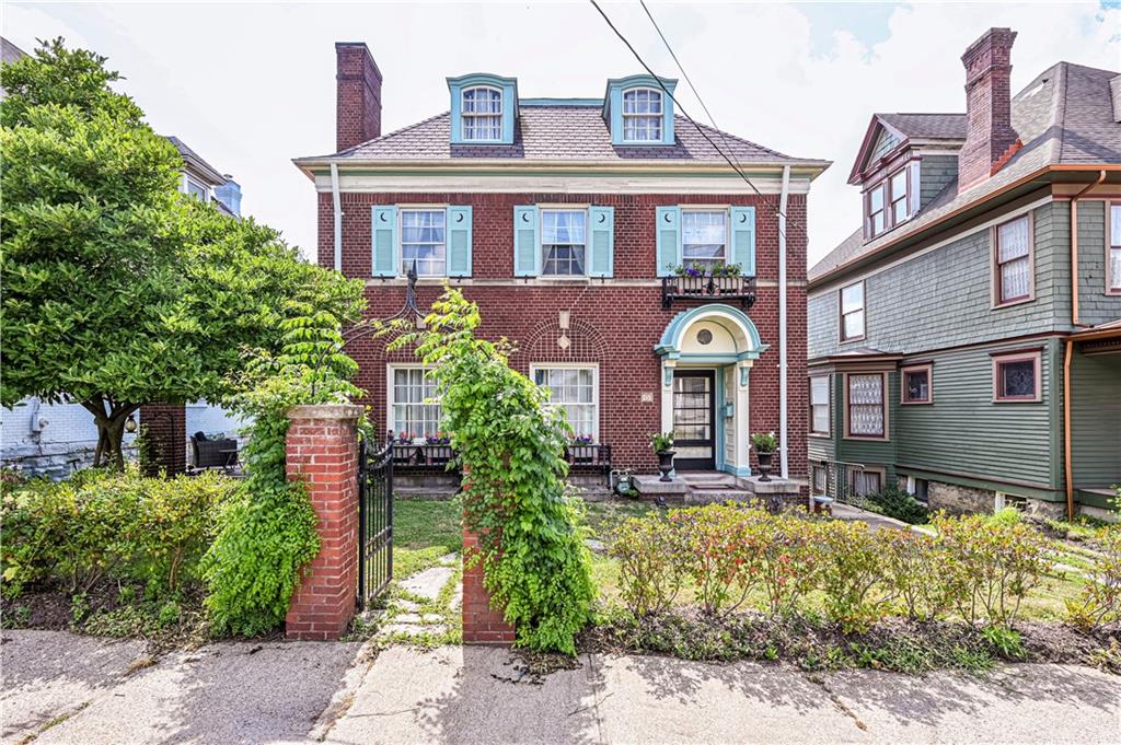 a front view of a house with garden