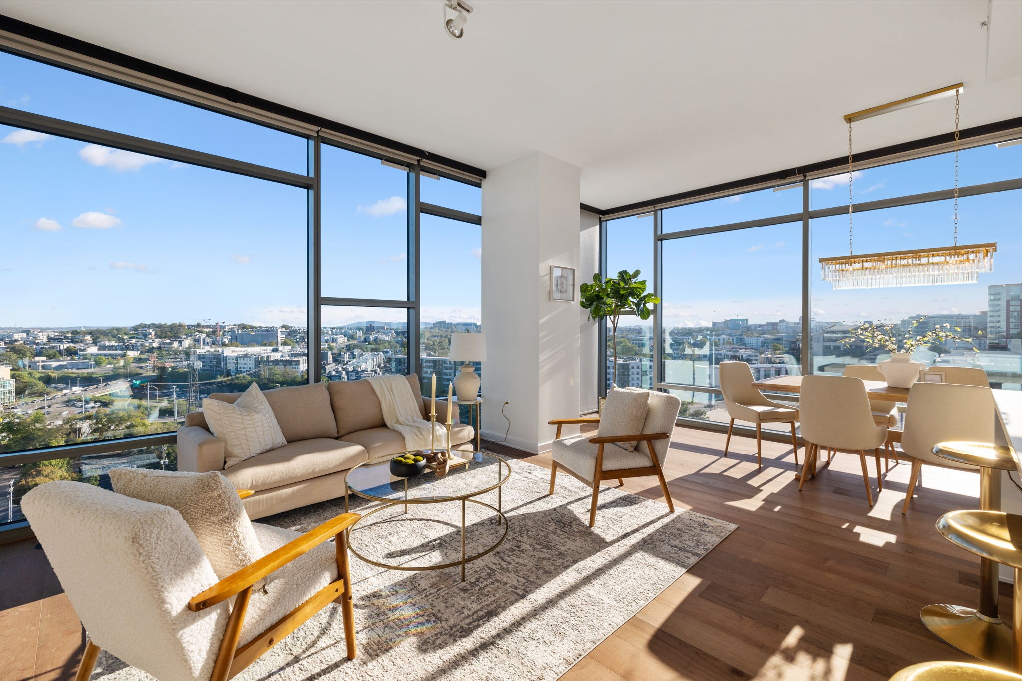 a living room with furniture city view and large windows