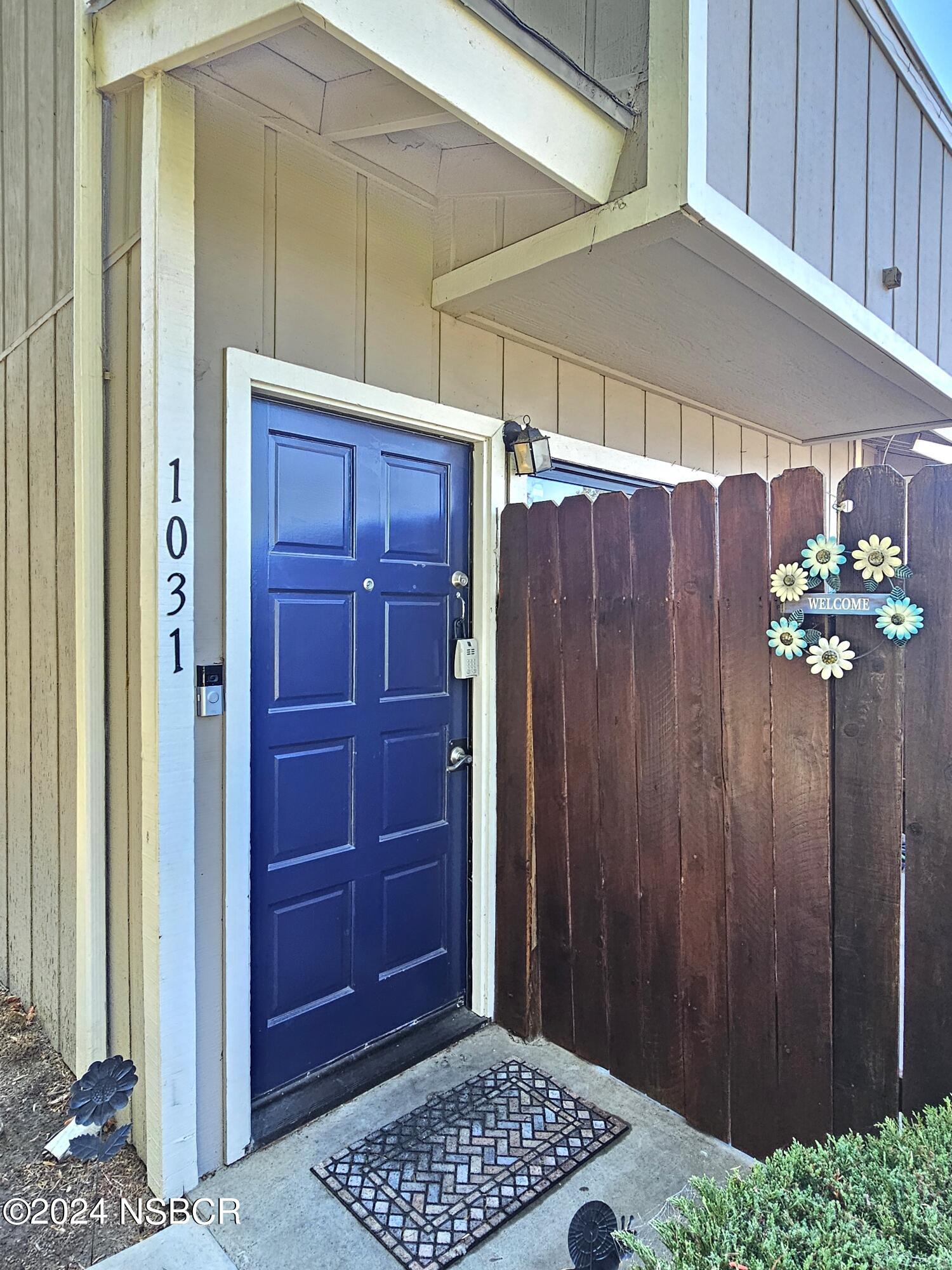 a view of a wooden door and a door