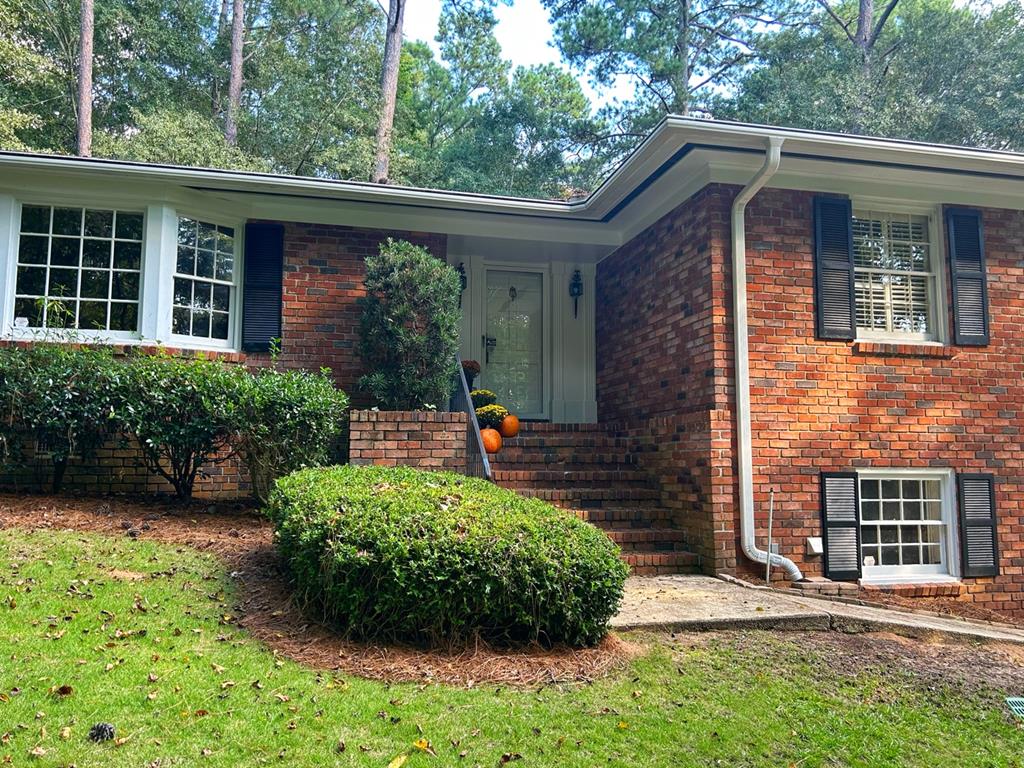 a front view of a house with garden