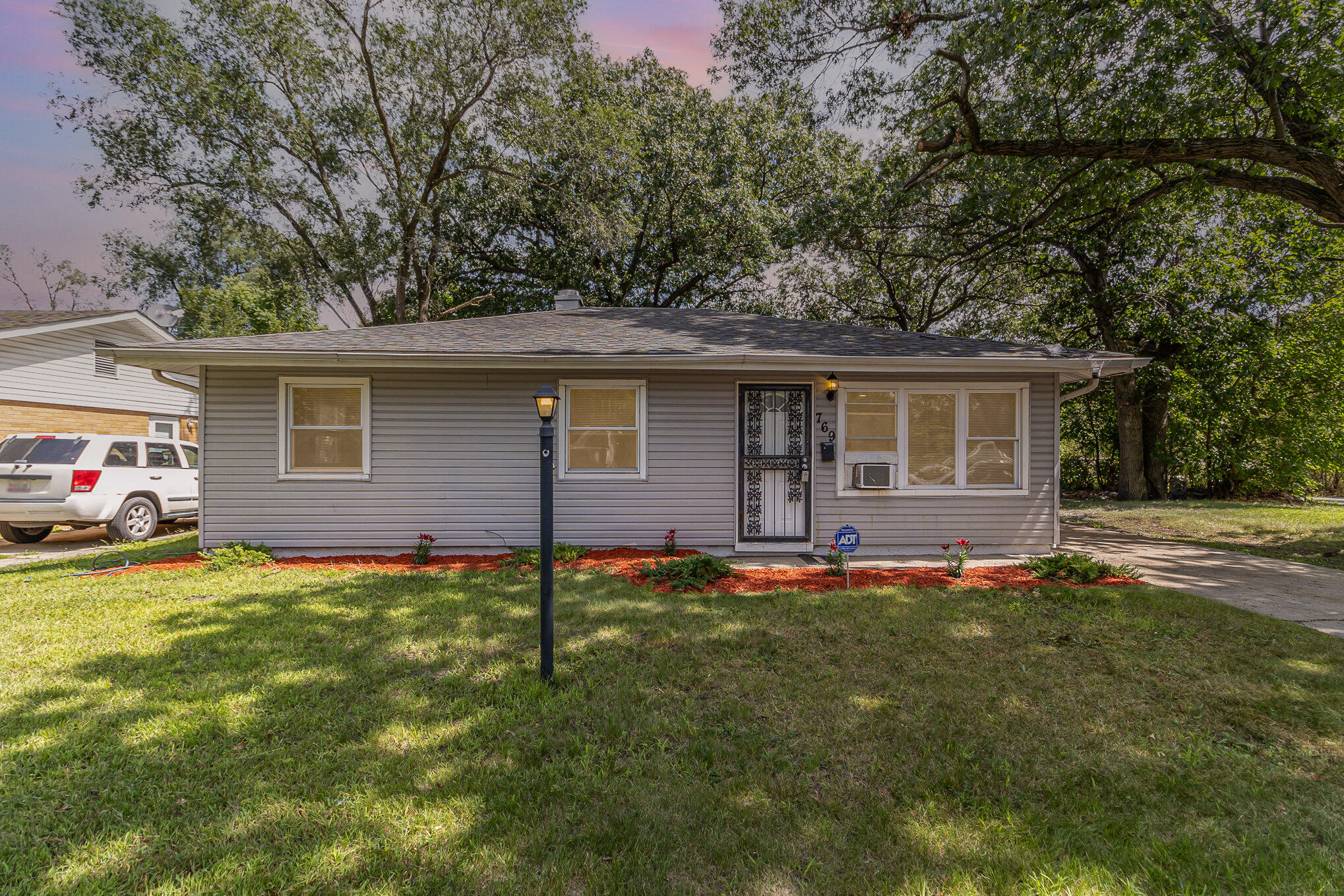 a front view of house with yard and trees