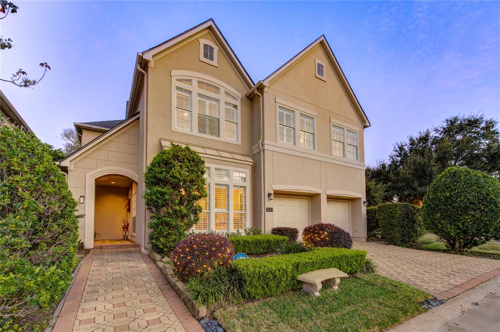 Welcome to this stucco home with an elegant curb appeal and lush greenery.