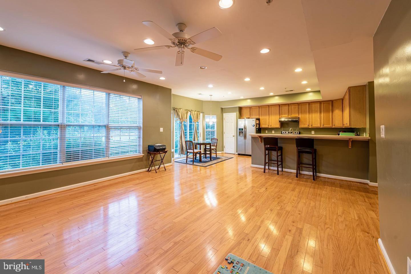 a view of a kitchen with kitchen island a large window a sink and counter space