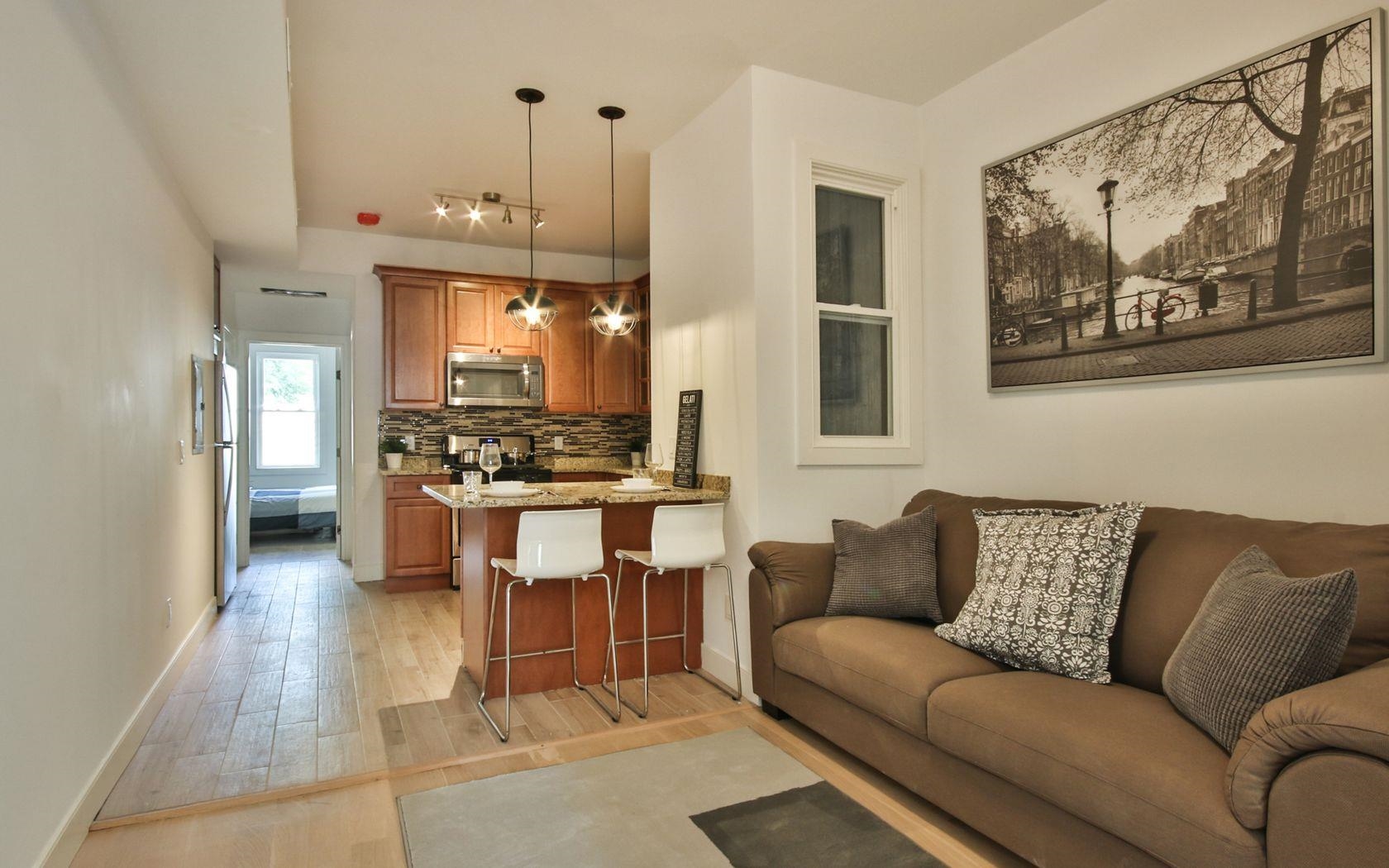 a living room with furniture and kitchen view