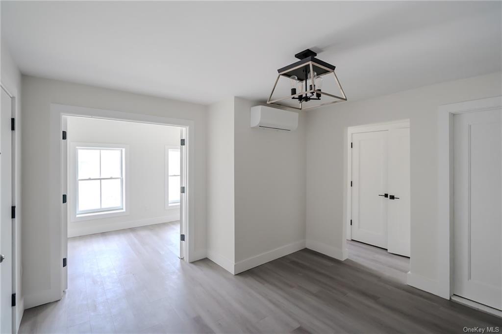 Living room featuring a wealth of natural light and light wood-type flooring