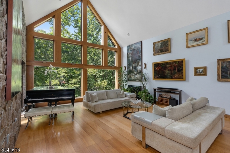 a living room with furniture large window and a flat screen tv