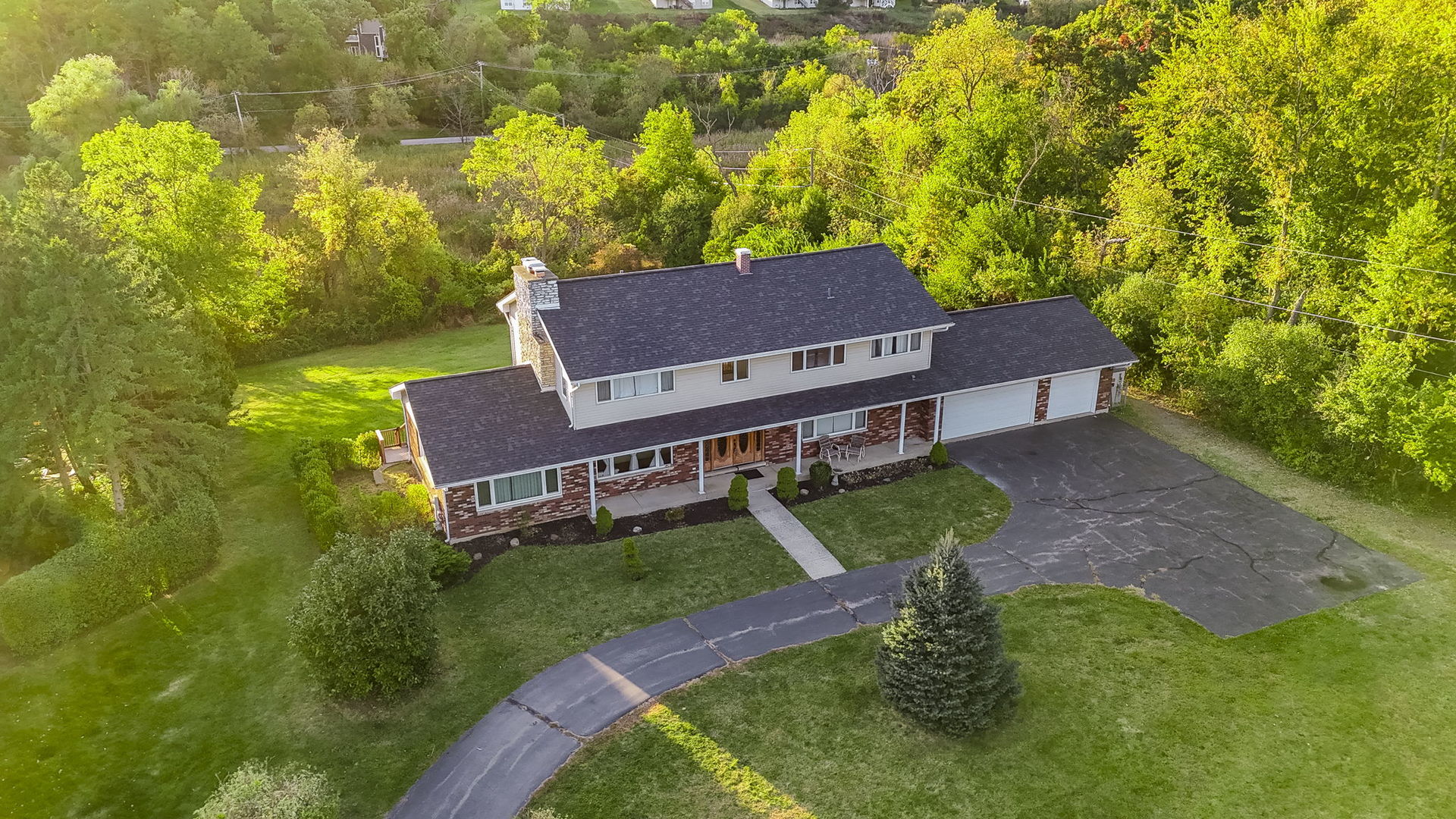 an aerial view of a house with a big yard