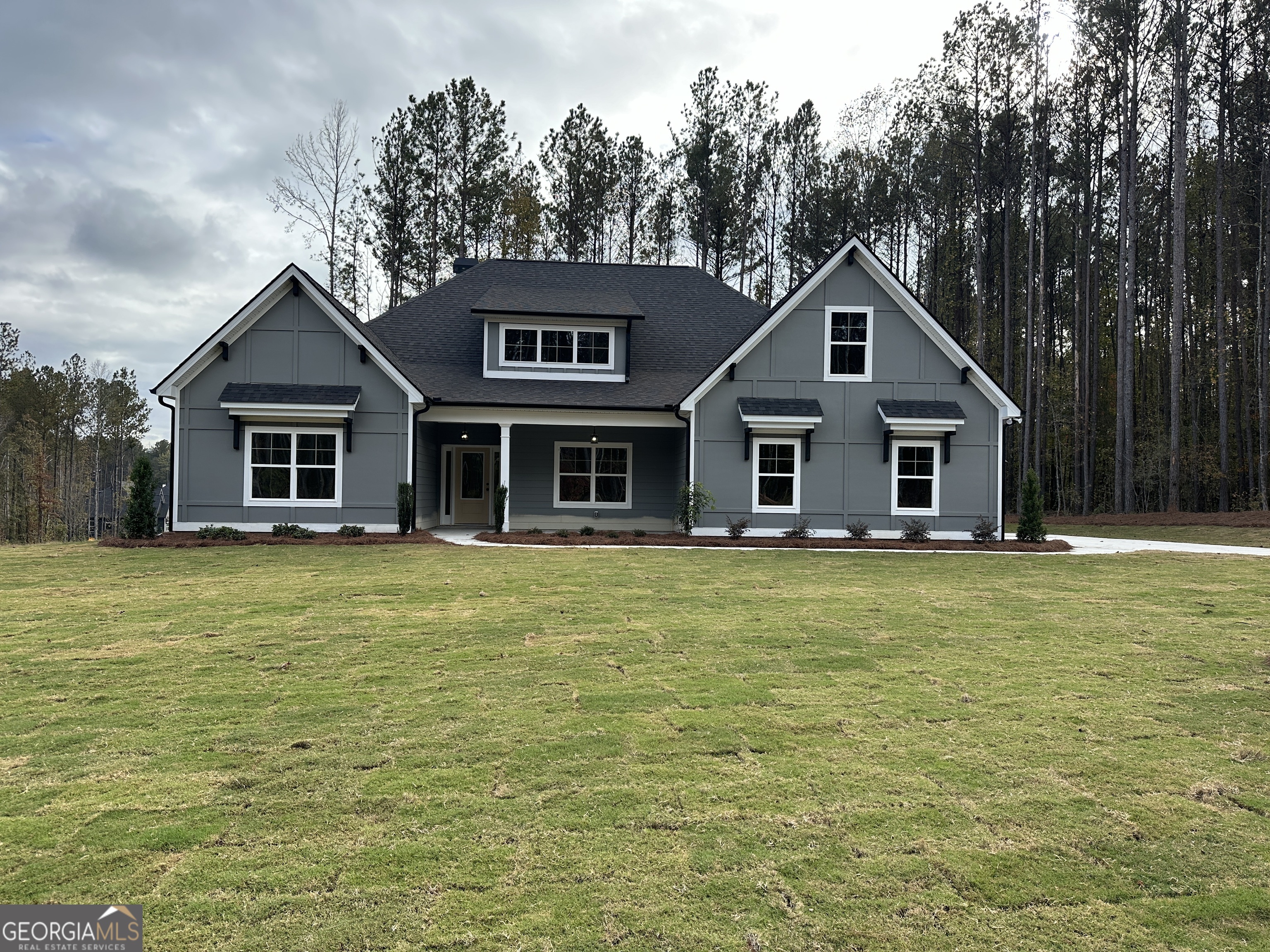 a front view of a house with a garden