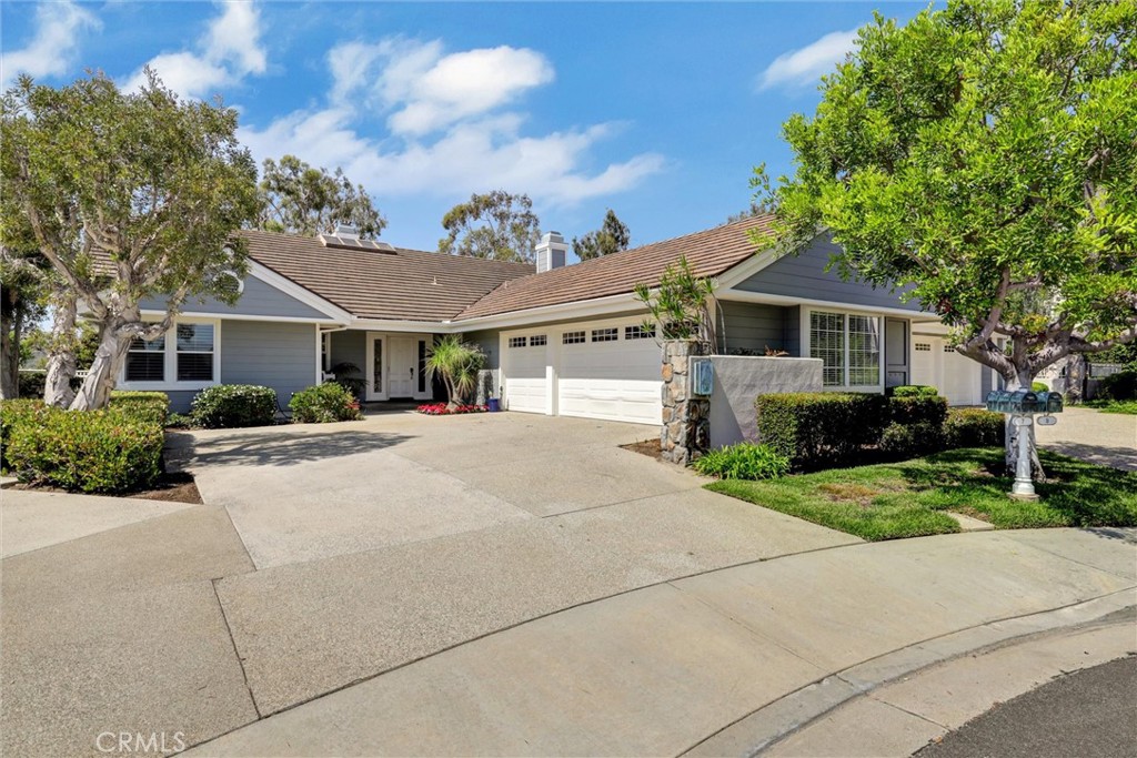 a front view of a house with yard and trees