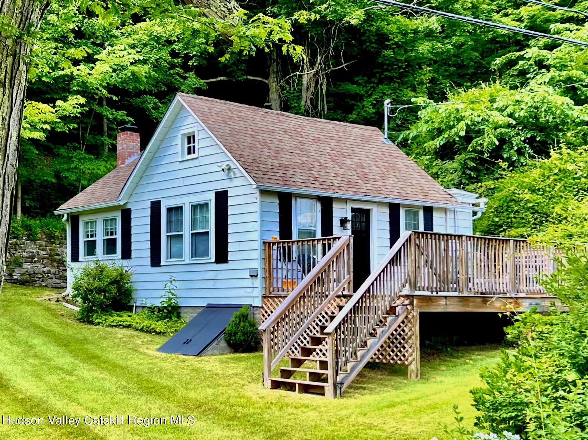 a view of a house with a yard and deck