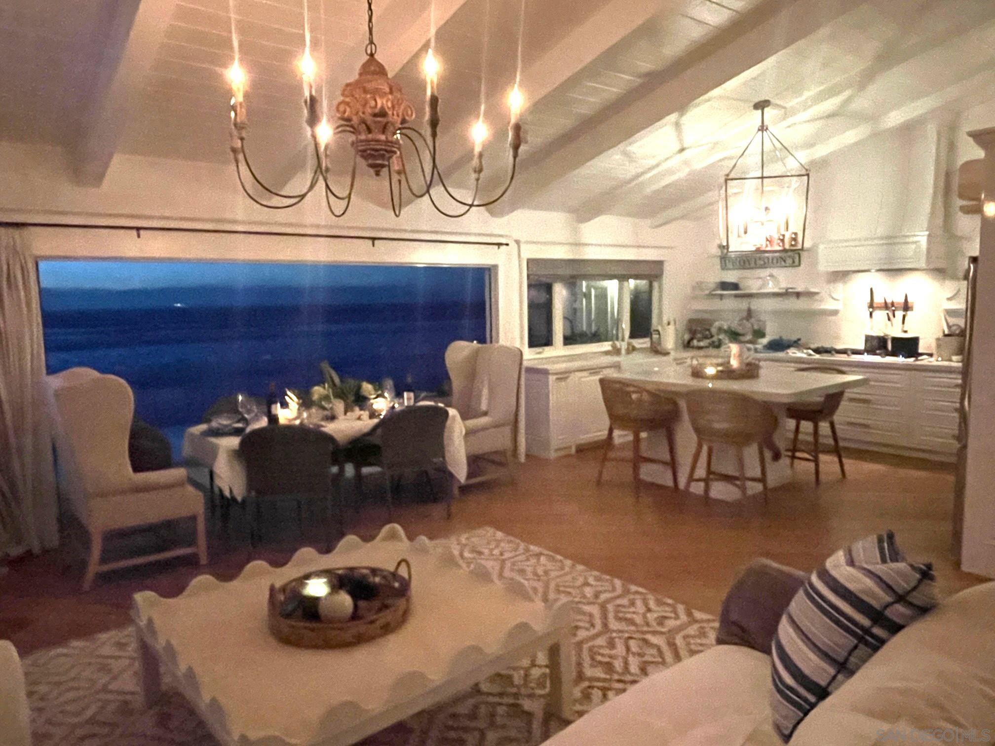 a living room with furniture a chandelier and a fireplace