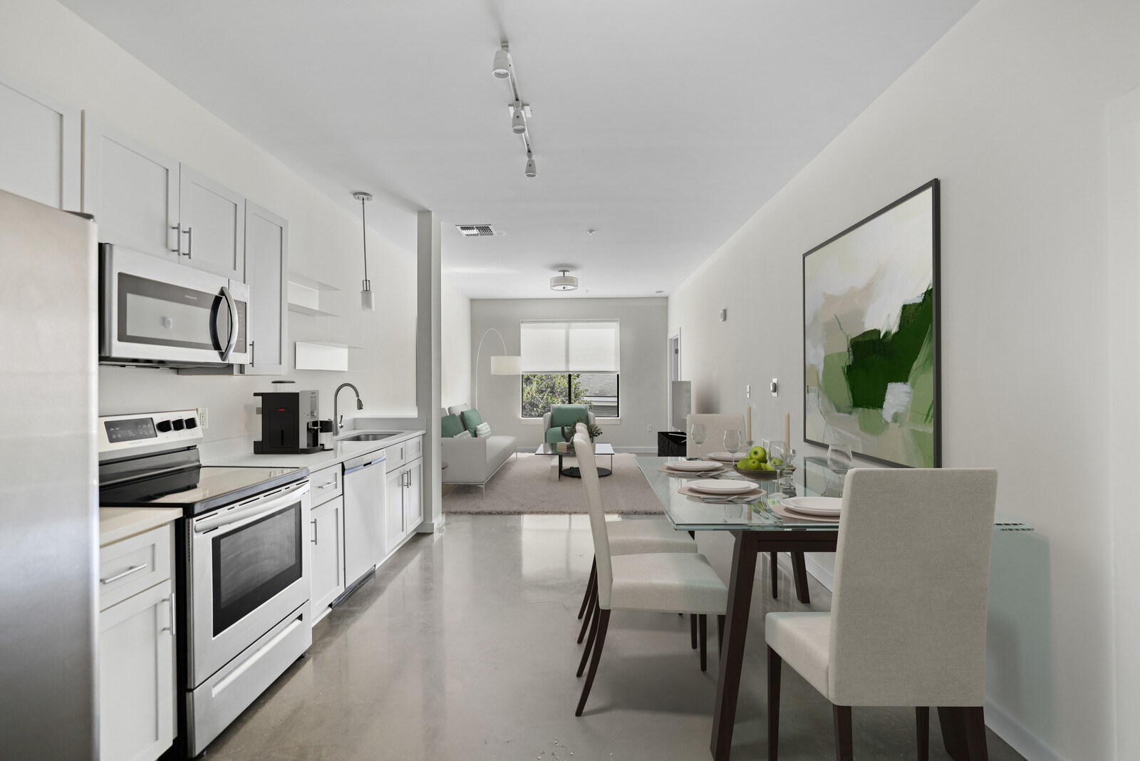 a view of kitchen with stainless steel appliances granite countertop a stove a sink dishwasher a microwave oven and a refrigerator with wooden floor