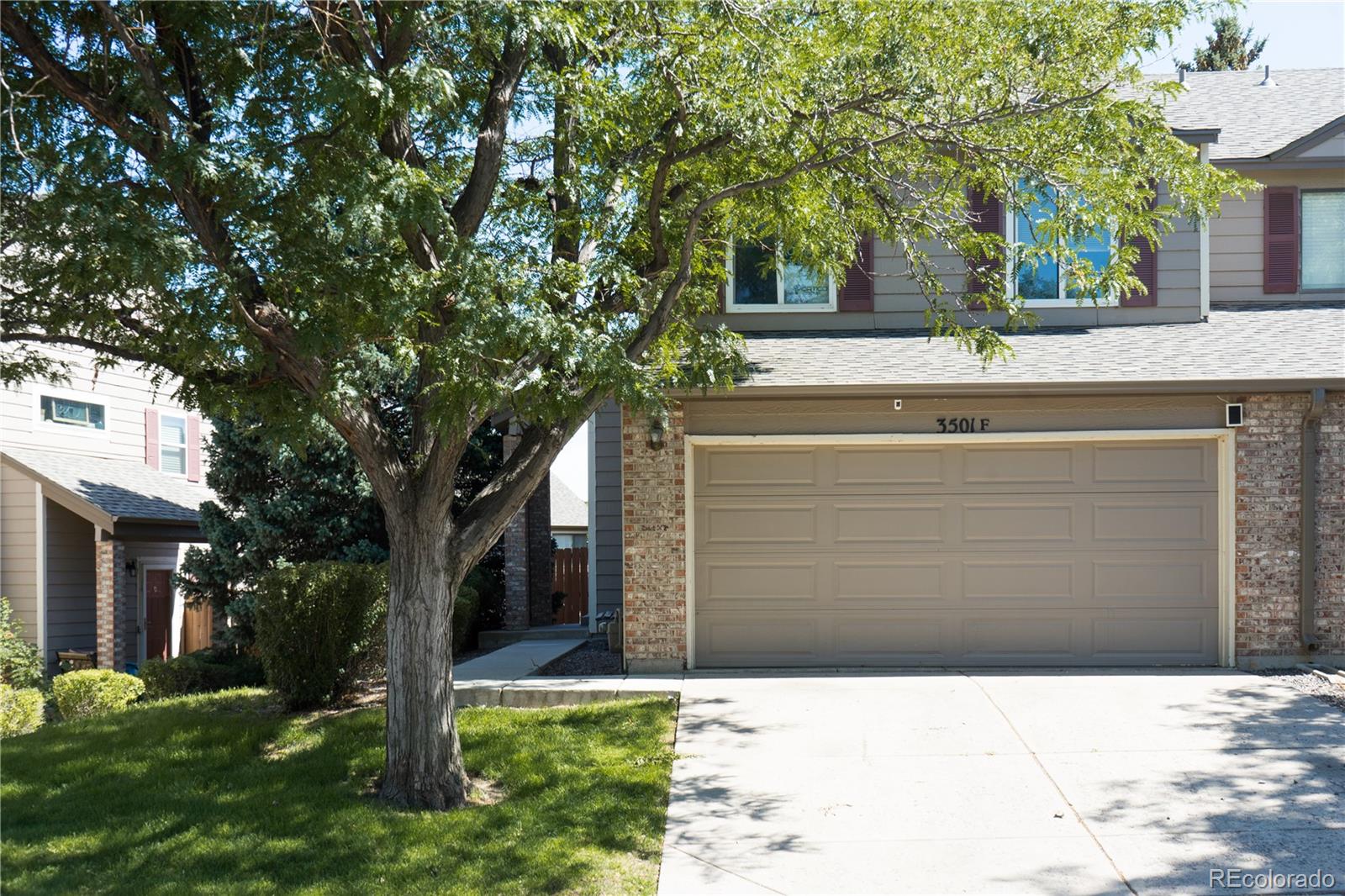 a view of house with a tree in front of it